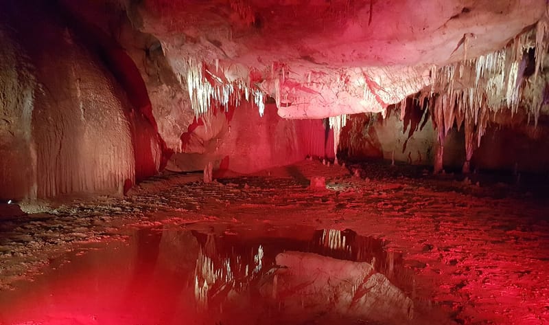 Illuminated stalactite formations inside Prometheus Cave — 3
