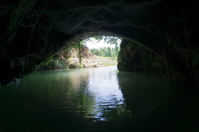 Illuminated stalactite formations inside Prometheus Cave