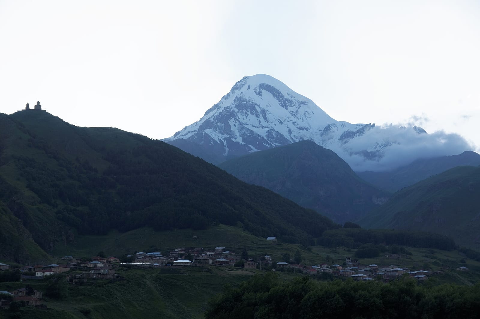 Snow-capped peak of Mount Kazbek at sunset