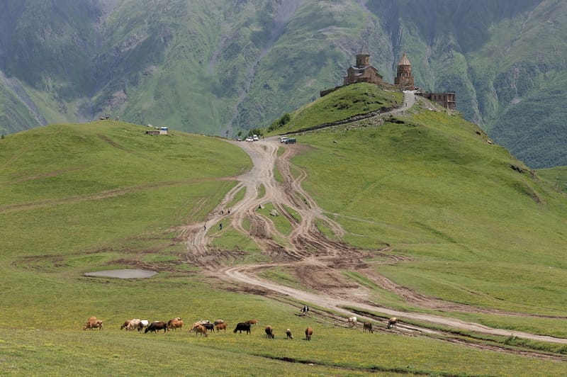 Gergeti Trinity Church with Mount Kazbek looming behind it — 3